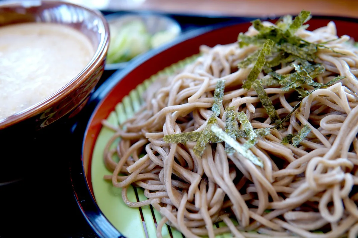 Cold buckwheat soba on a bamboo mat, topped with thin strips of nori