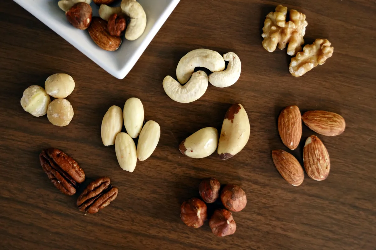 Walnuts, Brazil nuts, cashews, almonds, pecans and hazelnuts on a wooden table