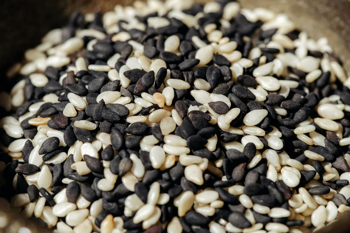 A close-up of mixed black and white sesame seeds