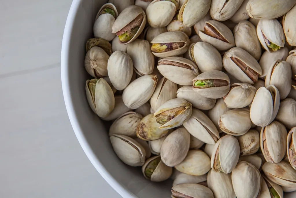 A bowl full of pistachios in their shells