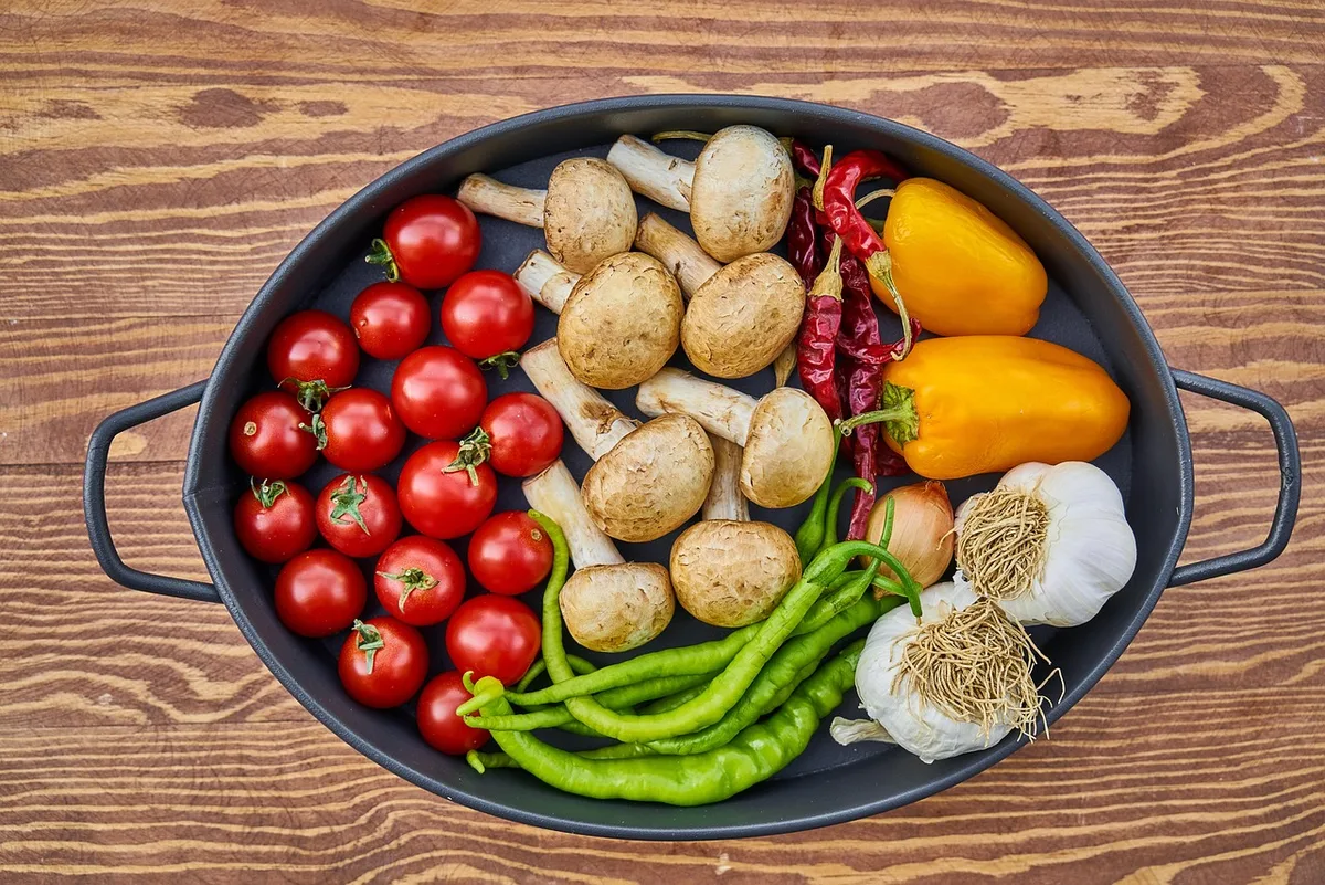 Cherry tomatoes, button mushrooms, garlic and peppers packed into a cast iron dish