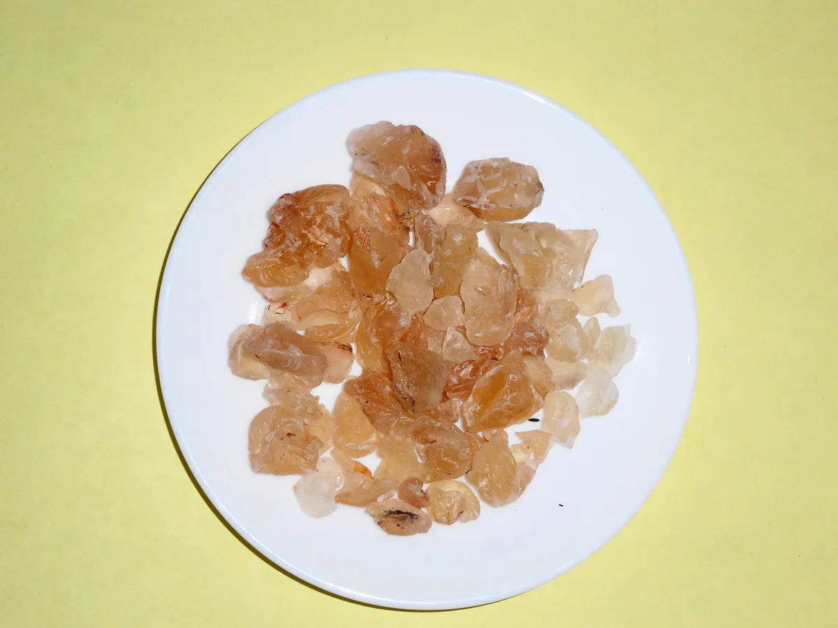 Pieces of dried edible gum on a white plate